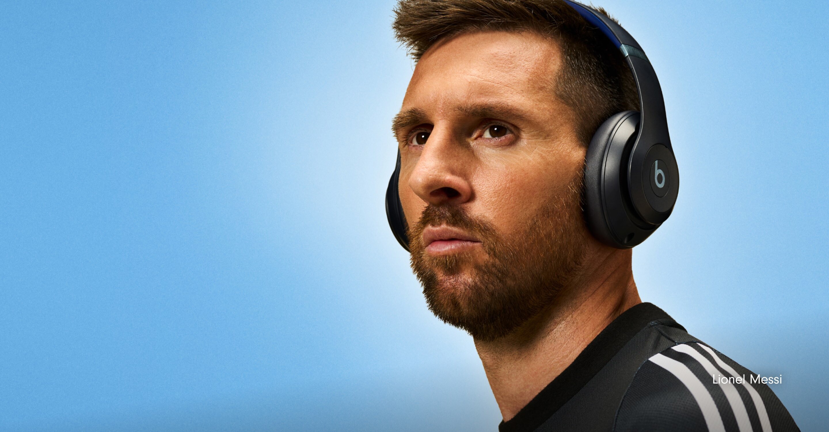 Soccer player Lionel Messi wearing Beats Studio Pro headphones, with the text "Rewrite History" overlaid on a light blue background.